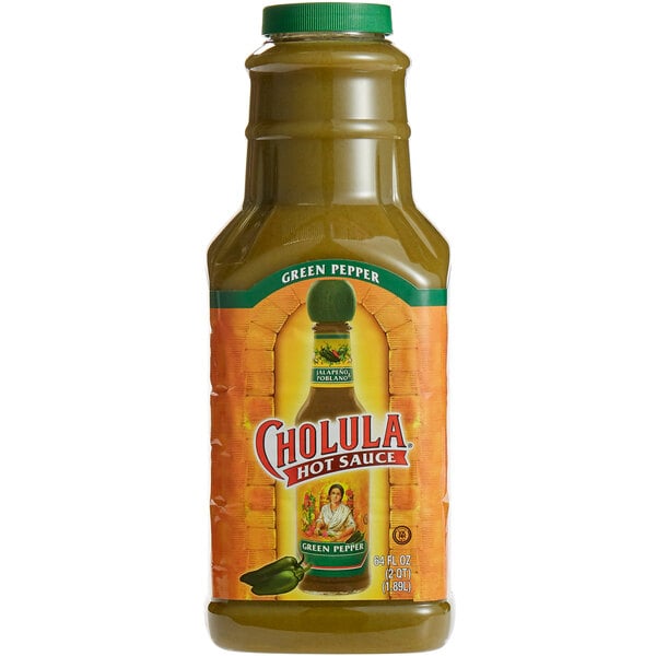 A close-up of a jar of Cholula Green Pepper hot sauce with a label.