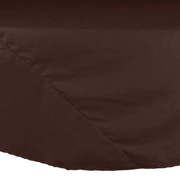 A brown Intedge round table cloth on a table.