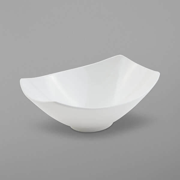 A white Bon Chef Gondola bowl with a curved edge on a gray background.