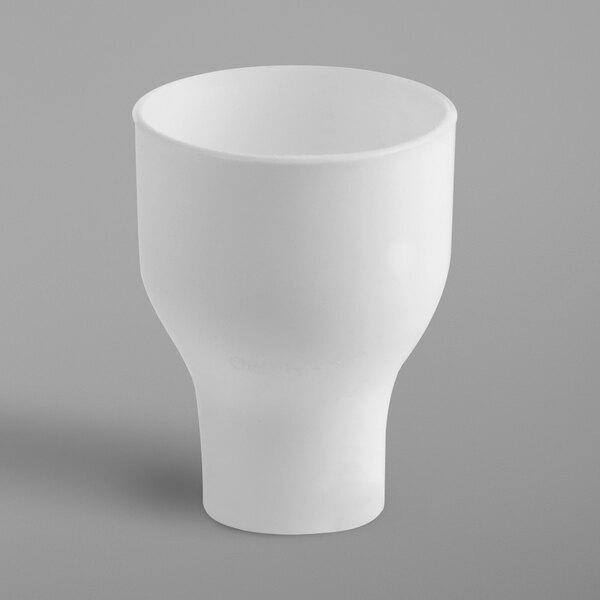 A white bowl with a black handle used as a funnel to refill salt and pepper shakers.
