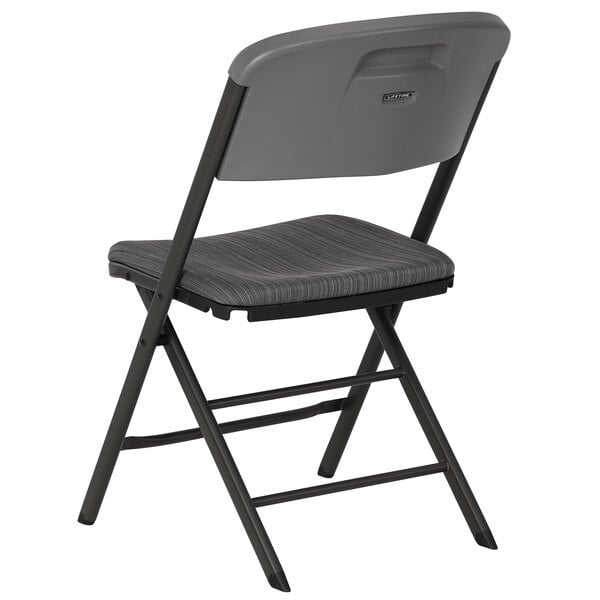 A gray padded folding chair with a grey seat and back.