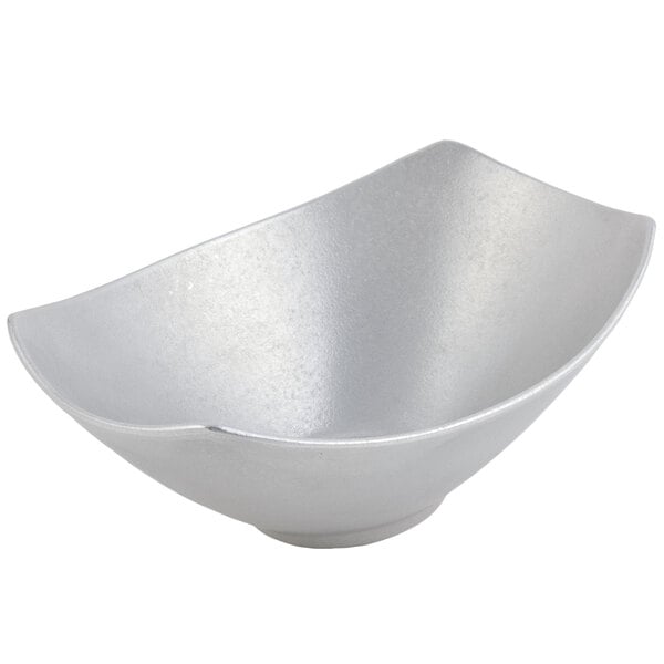 a silver bowl with a curved edge