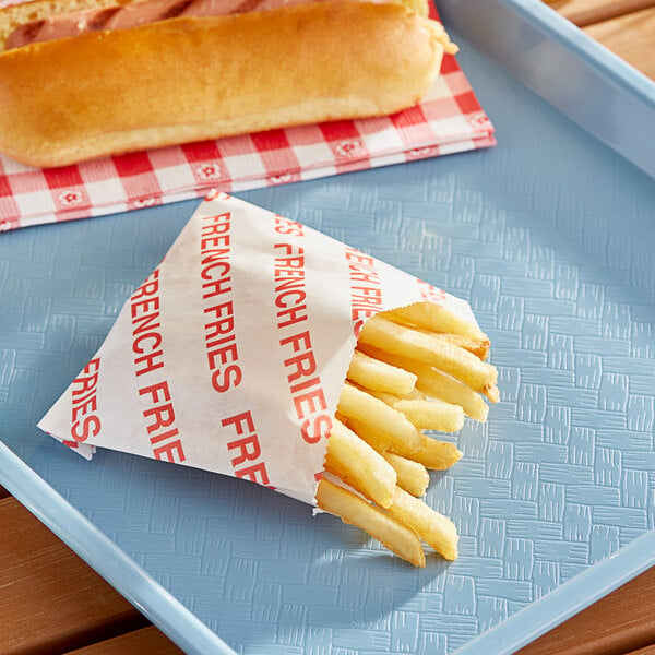 French fries in a Carnival King small printed paper bag on a tray.