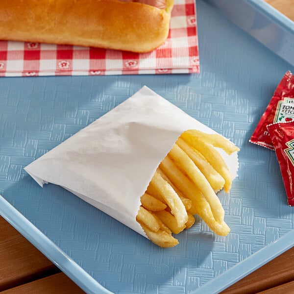 A tray of Carnival King small French fry bags filled with French fries.