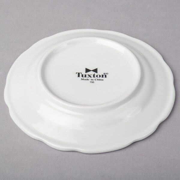 A Tuxton bright white china plate with black text on it.