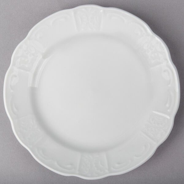 A Tuxton Chicago bright white china plate with a decorative edge.
