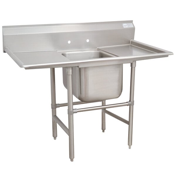 An Advance Tabco stainless steel pot sink with two drainboards.