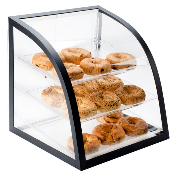 A Cal-Mil black iron bakery display case with bagels on it.