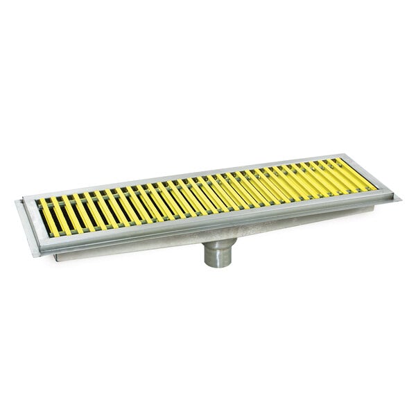 A metal floor trough with yellow fiberglass grating with white stripes.