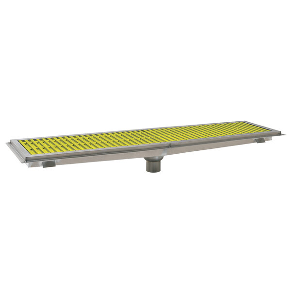 A metal floor trough with yellow fiberglass grating over it.