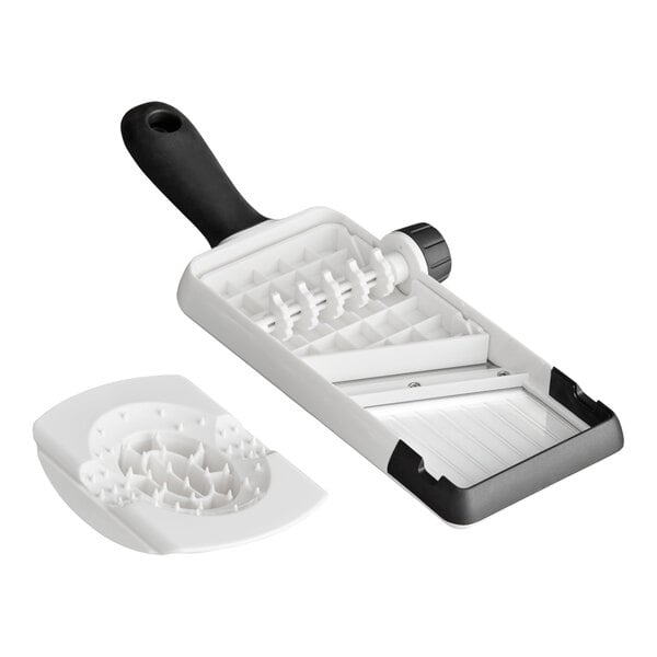 A handheld kitchen slicer with an adjustable blade and a separate white food holder, featuring a black handle and a dial for thickness adjustment.