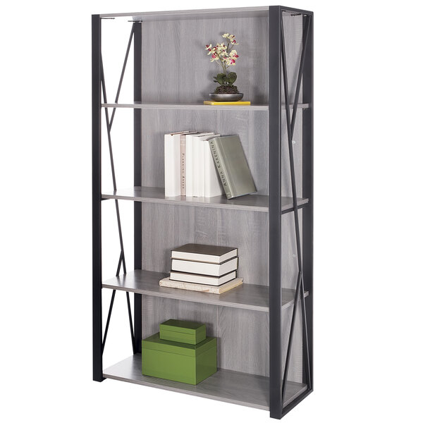 A Safco gray steel bookcase with books and a plant on it.
