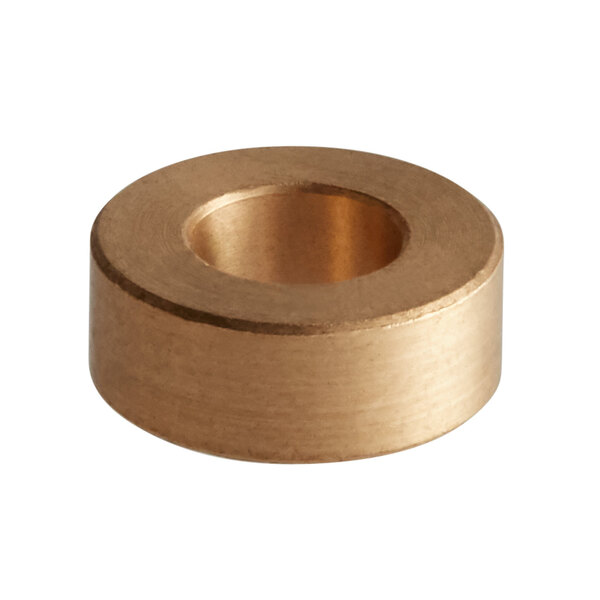 A Sunkist bronze bushing with a circular gold shape and a hole in the middle.