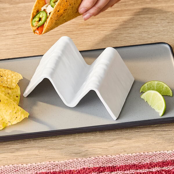 A white faux-slate melamine taco holder with one or two compartments, designed to hold tacos upright.