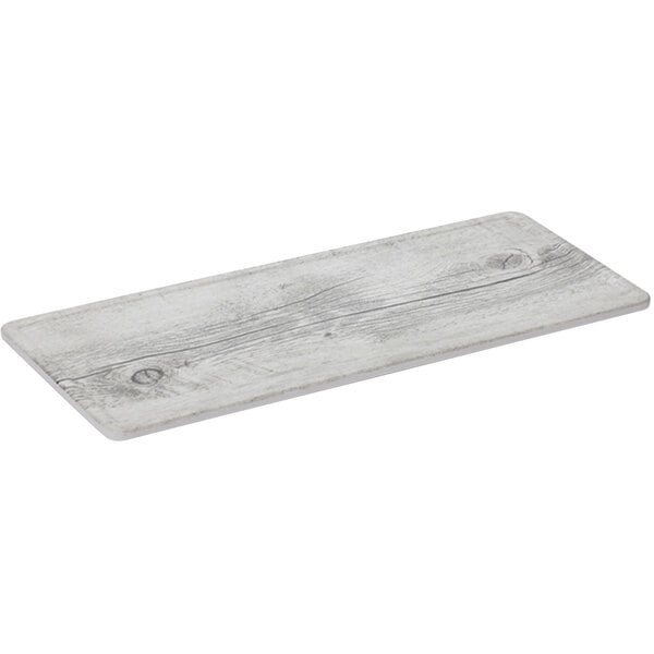 A white rectangular melamine display board with a faux white birch wood finish.