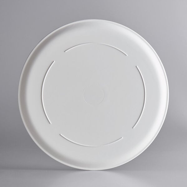 A white plate with a circular design on a white surface.