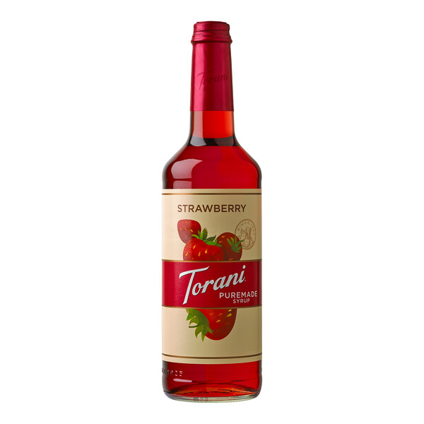 A close up of a Torani Puremade strawberry syrup bottle with a strawberry on the label.