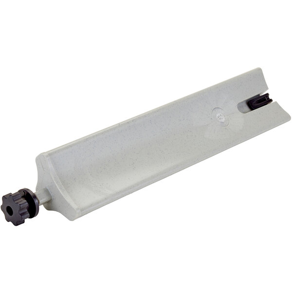 A white rectangular plastic object with a black pipe and wheel.