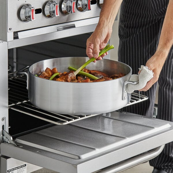 a person holding a green stalk of meat