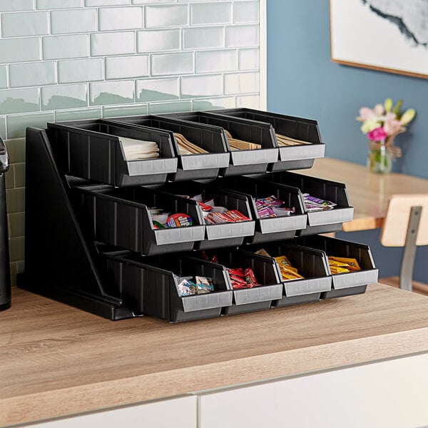 A black Cambro self-serve condiment stand with black bins on a metal pole.