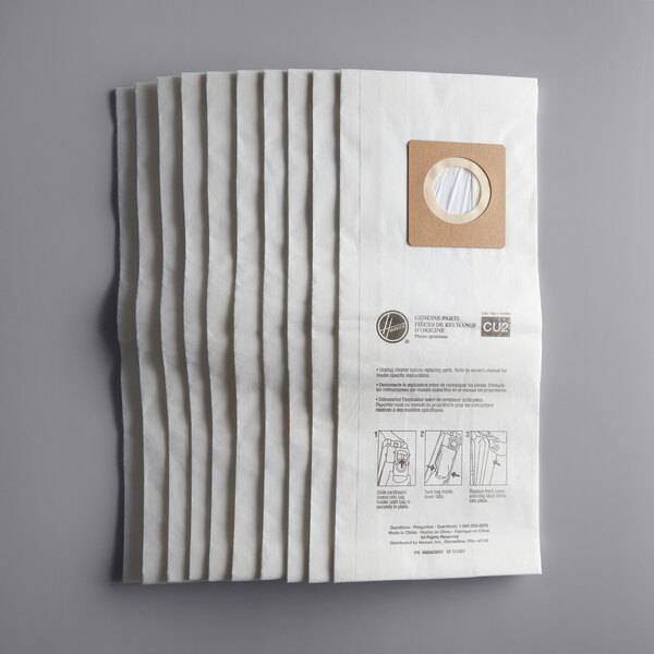 A stack of white Hoover CU2 upright vacuum bags with a hole in the center.