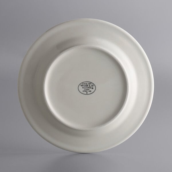 A close-up of a white Libbey stoneware plate with a small design on the edge.