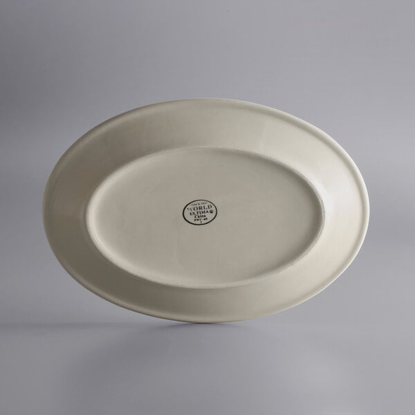 A white oval platter with a black logo on it.