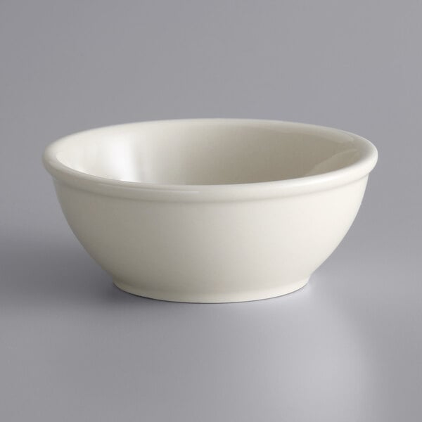 A Libbey Princess White stoneware oatmeal bowl with a rolled edge on a white surface.