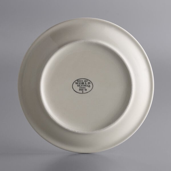 A close-up of a white Libbey stoneware plate with a black logo.