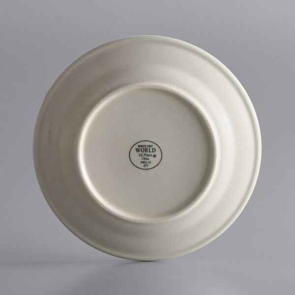 A close-up of a Libbey Princess White stoneware plate with a small design in white.