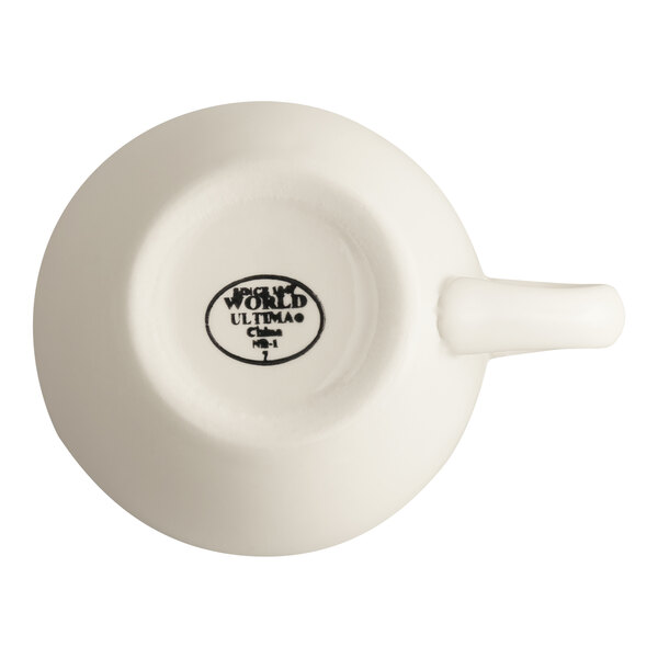 A white stoneware cup with a handle, shown from the bottom with branding and product information visible.