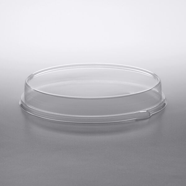 A clear plastic Solut low dome lid on a round plate.