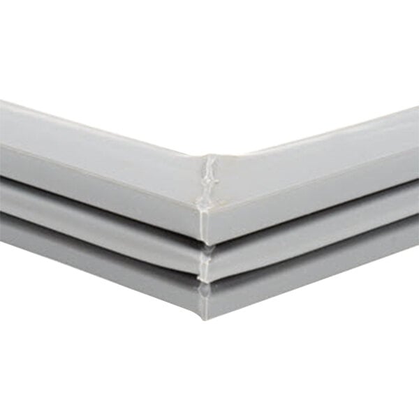 A close up of a gray corner piece of a Beverage-Air magnetic door gasket.