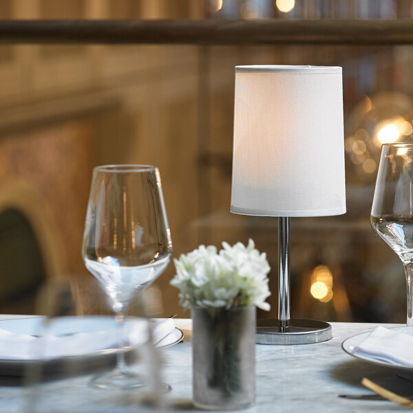 A table set with a Sterno Martini Cool lamp and wine glasses.