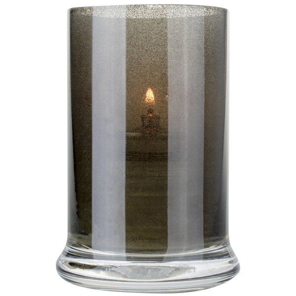 A candle in a glass vase.