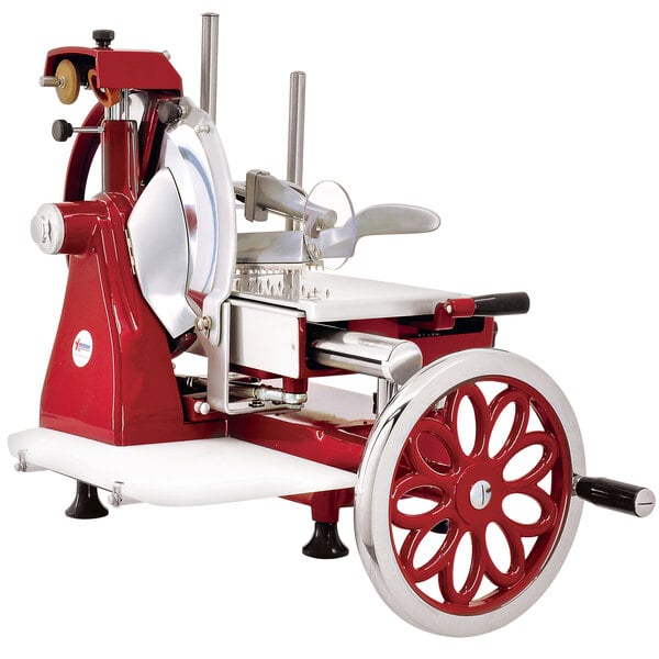 An Omcan red and white manual meat slicer with a flower flywheel.