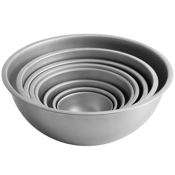 A stack of 3 silver Vollrath mixing bowls.
