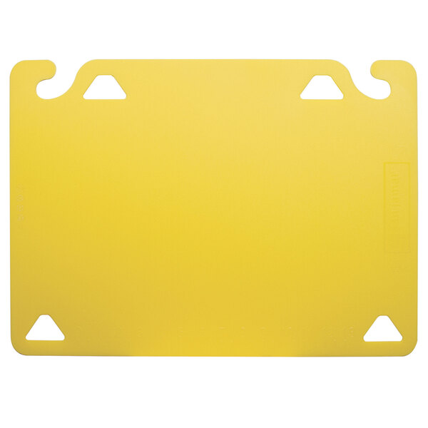 A yellow plastic cutting board with two holes.