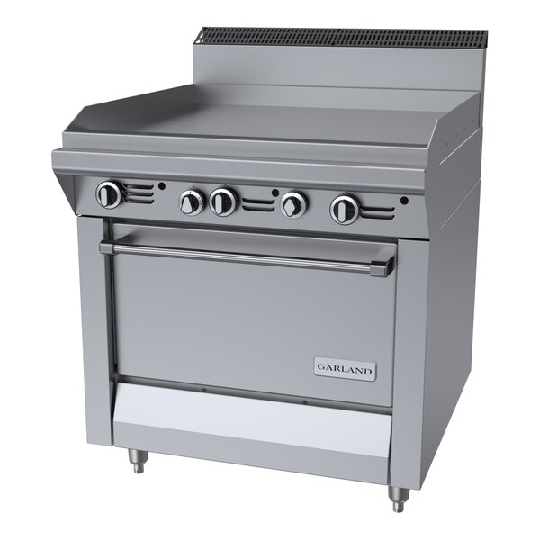 A commercial stainless steel natural gas griddle top range with a standard oven and control knobs.
