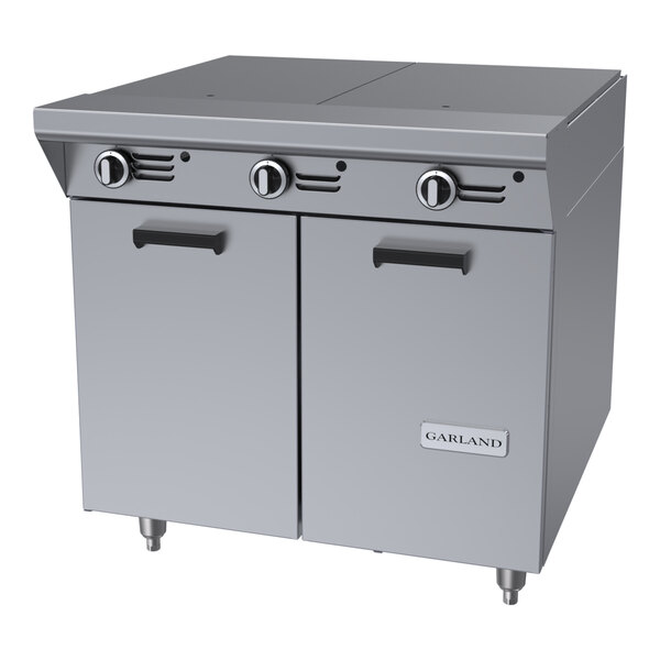 A stainless steel commercial hot top range with three control knobs and a double-door storage base.