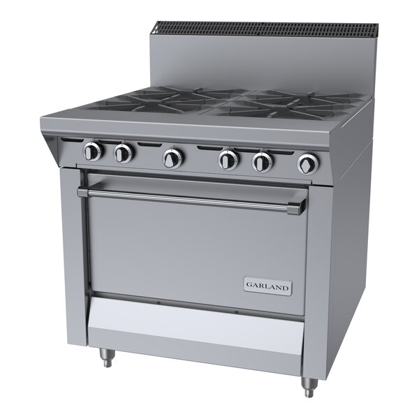 A commercial stainless steel 4-burner range with an oven, designed for use with liquid propane.