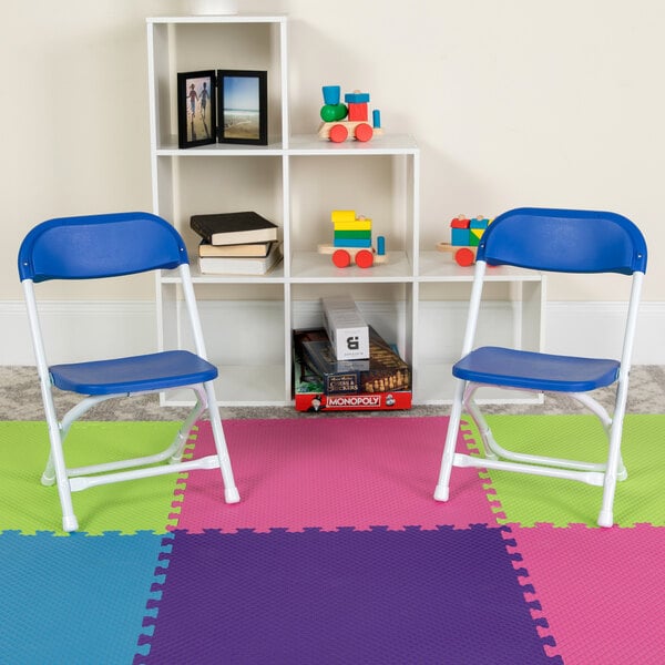 two child-sized blue chairs on a puzzle mat