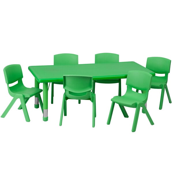 A green plastic rectangular table with green chairs next to it.