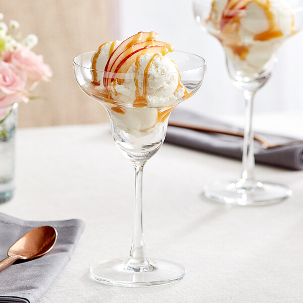 A close-up of a Acopa Covella margarita glass with ice cream and caramel sauce.
