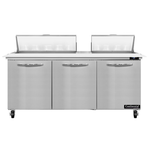 A stainless steel Continental Refrigerator with a white cutting top over three doors.