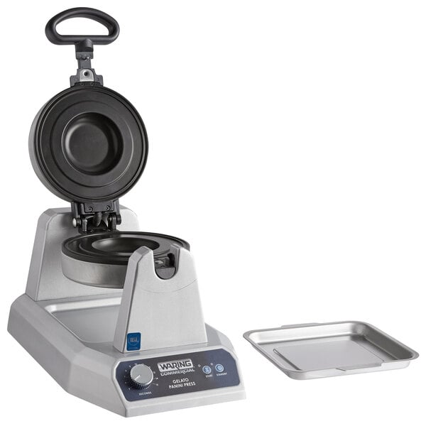 A Waring commercial panini press with a silver tray on top.