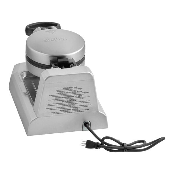 A silver Waring gelato and ice cream panini press with a black handle and attached power cord.