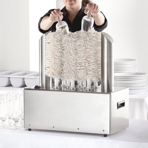 A woman using a Noble Glass Genie electric glass polisher with eight brushes.