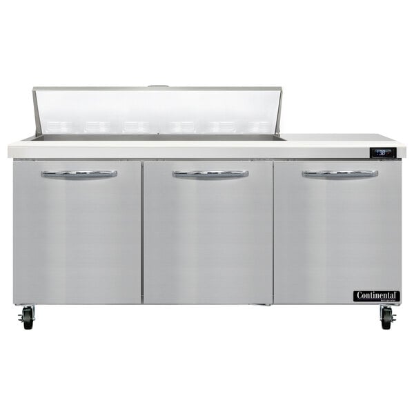 A stainless steel Continental Refrigerator with three doors and a counter top.