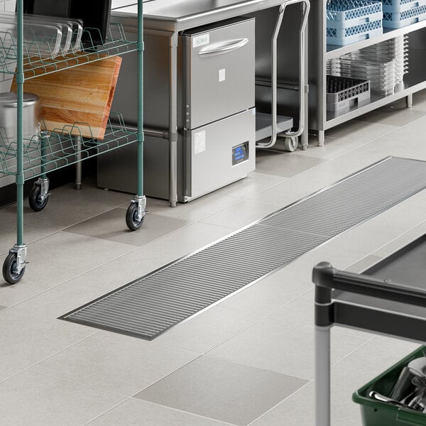 An 18-inch by 120-inch stainless steel floor trough with a grate, designed for commercial kitchen drainage.